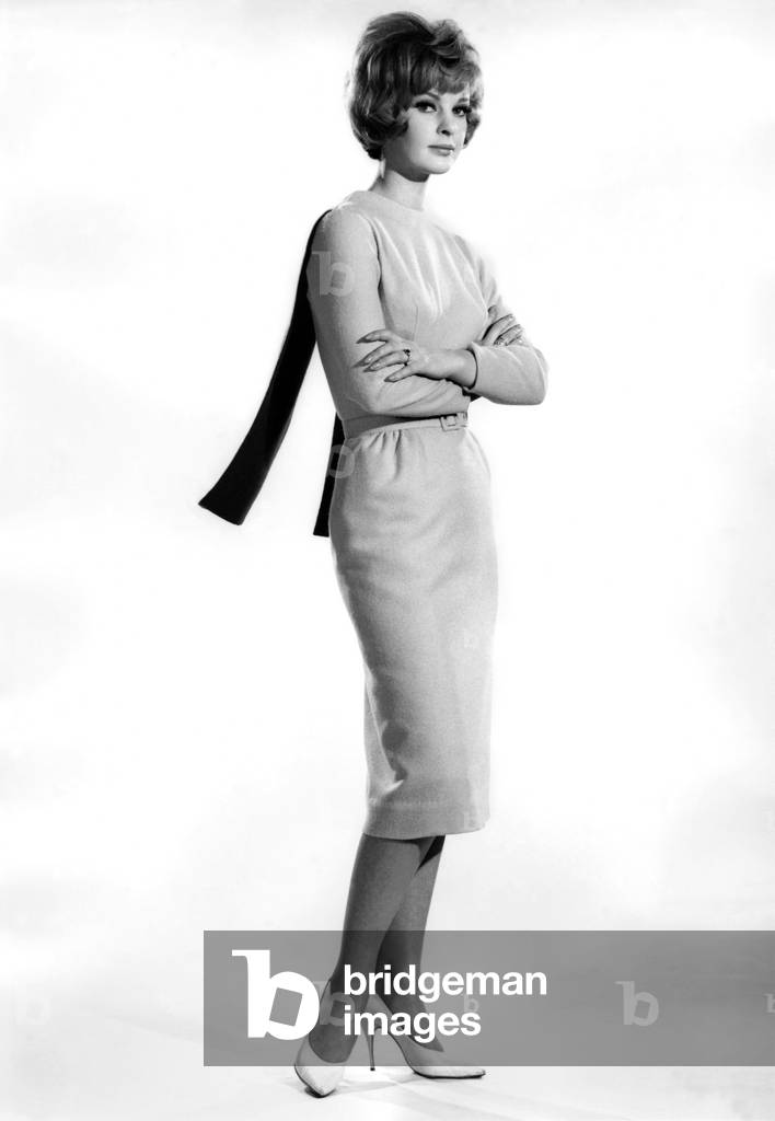 Model Dawn Chapman wearing long dress, arms folded. February 1962