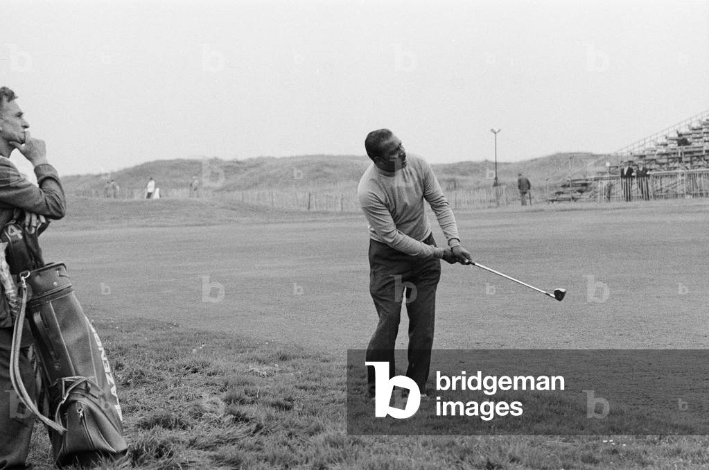 Golf tournament held at Royal Birkdale. South African golfer Sewsunker Sewgolum plays a shot out of the rough. 31st August 1966 (b/w photo)