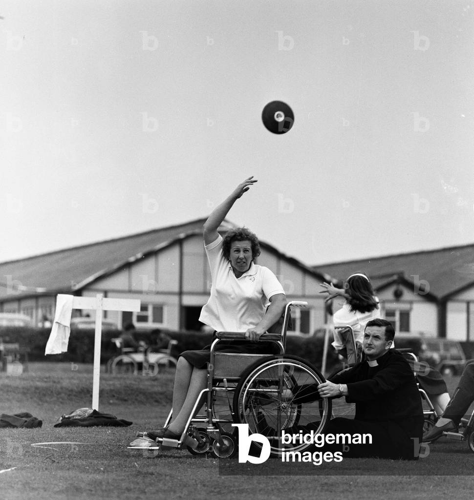 Paralympic Athletes training at Stoke Mandeville, watched by patients, ahead of the 1964 Paralympics to be held in Tokyo, pictured 22nd July 1964 (b/w photo)