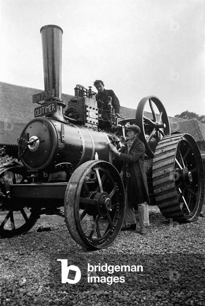 Farmer Crithus Nappes wins the tractor engine race from his friend Miles Chetwyrd- Stapleton at Appleford, Buckinghamshire. August 1950 (b/w photo)