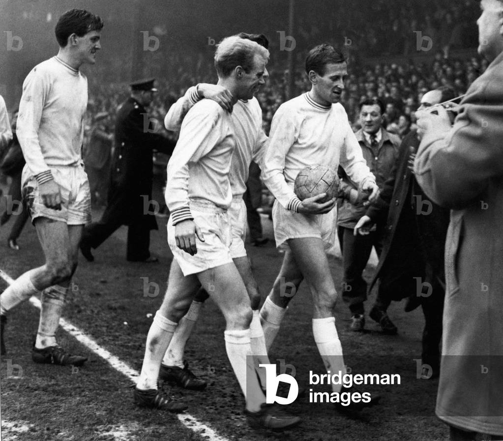 Sport - Football - Swansea Town - Swansea players leave the field at Anfield after their victorious defeat of Liverpool 2-1 in the FA Cup Quarter Final watched by Liverpool's Bob Paisley in the background - 29th February 1964 (photo)