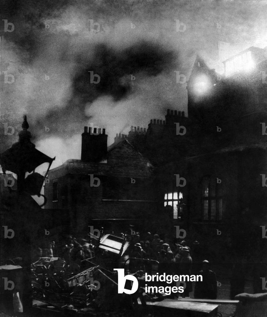 Tip and run raid. Removing furniture from buildings which are blazing at Marylebone after a V1 flying bomb attack. March 1944