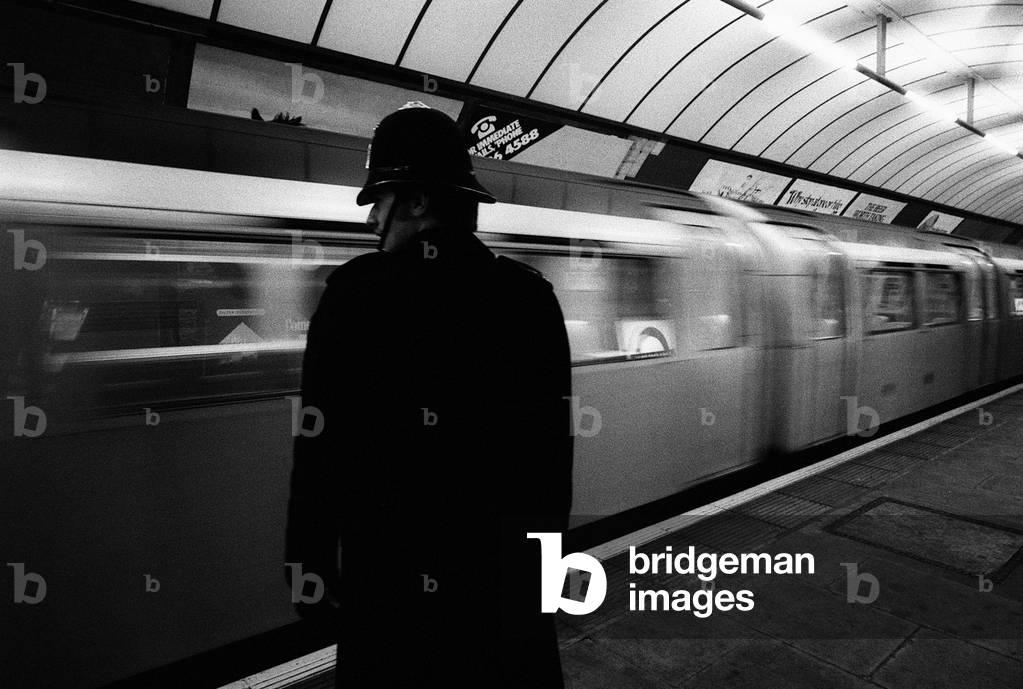 Following a series of terrorist attacks across the capital a policeman seen here patrolling a platform on the London Underground March 1976 (b/w photo)