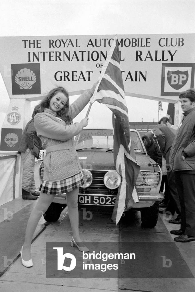 R.A.C. Rally: Miss U.K. Sheena Drummond, Waves the flag for the start of the R.A.C. Rally. November 1969
