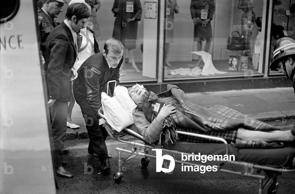 Some of the injured, who were mostly women shoppers being taken away by ambulance after a bomb had exploded in a lorry containing sherry bottles in Callander St. Belfast. January 1972 72-541-001