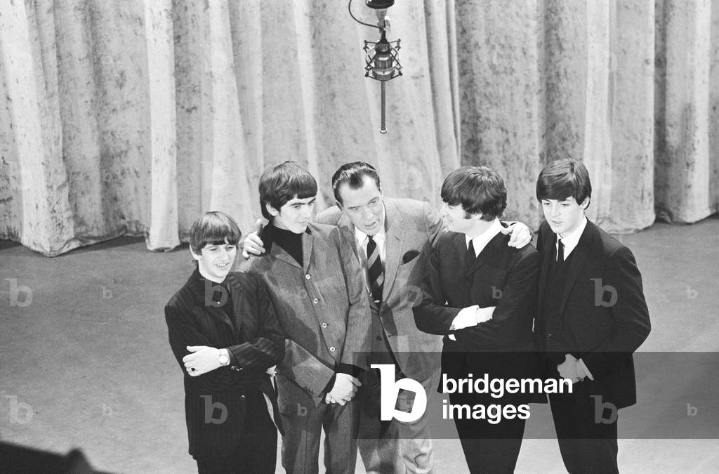 British pop group The Beatles with American talk show host Ed Sullivan on the set of his television show during the band's visit to the United States. 9th February 1964 (b/w photo)