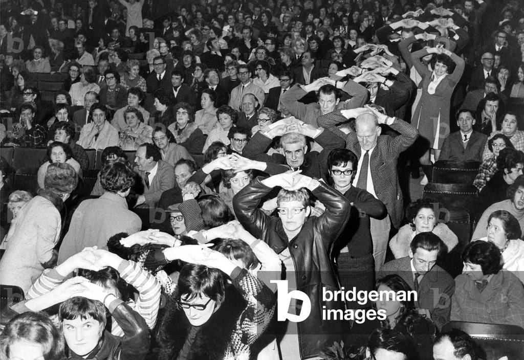 The audience line up to get on stage so Romark the hypnotist can help them to give up smoking at the City Hall, Newcastle in March 1971 (b/w photo)