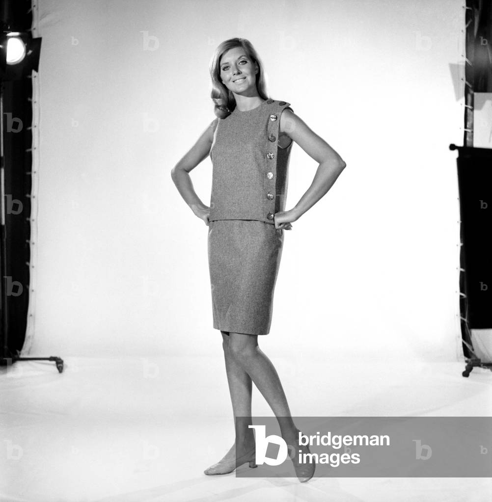 Clothing: Fashion: Maureen Walker Modelling: Grey dress, skirt and two jackets. 1961 (b/w photo)