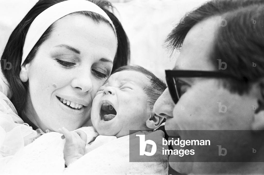 Conductor Sir Edward Thomas Downes and his wife Joan seen here at the Royal Northern Hospital, Holloway Rd, London with their son Caractacus. 15th December 1967 (b/w photo)