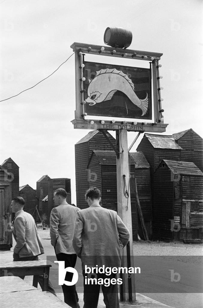 Holiday scenes in an around Hastings, East Sussex. The men leave the wives and go for a lunch time pint. June 1952 (b/w photo)