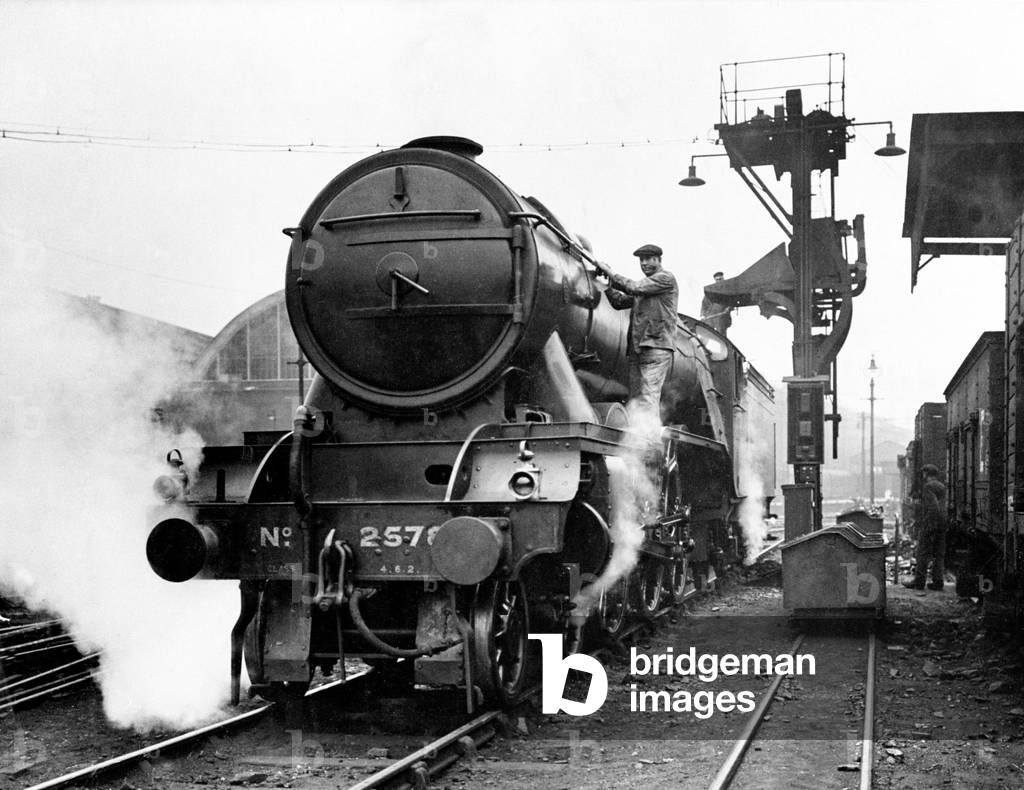 The LNER steam locomotive Bayardo seen here using the new electric coaling installation and inspection pit at Kings Cross Station. September 1929 (b/w photo)