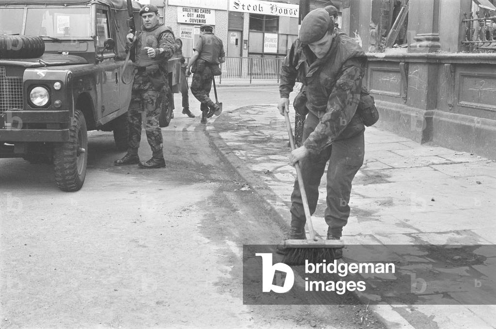 Soldiers from the Scots Guard seen here sweeping the streets of Londonderry following an explosion in the centre of town. 6th August 1972 (b/w photo)
