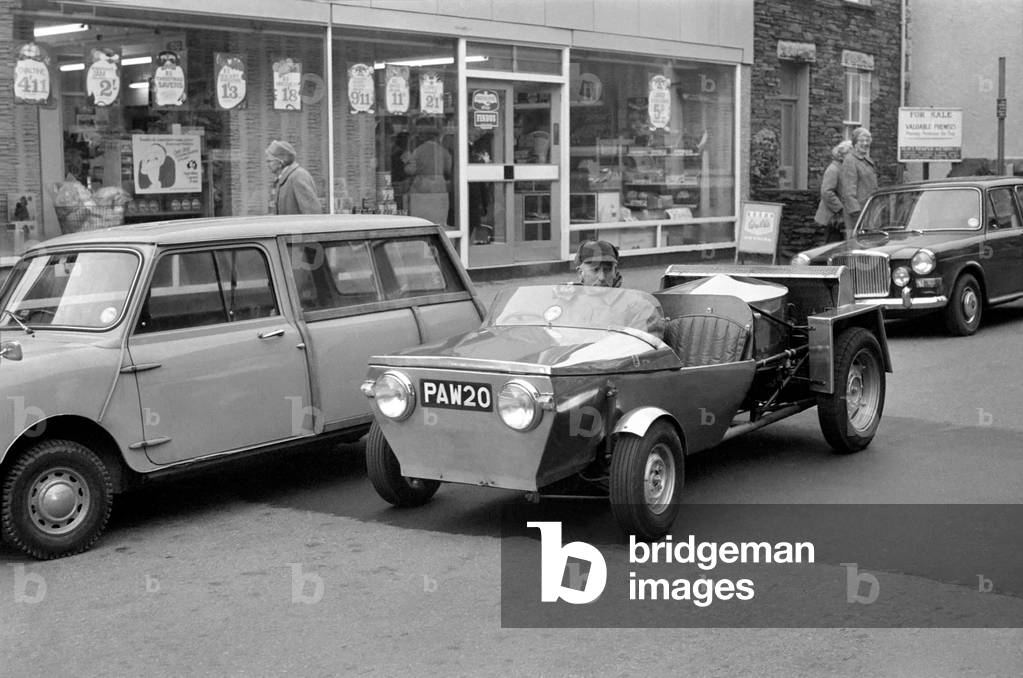 Man driving a steam powered car near his home
December 1970