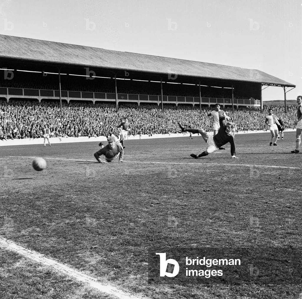 Blackburn Rovers v Manchester United, league match at Ewood Park, Saturday 3rd April 1965. Keeper Fred Else watches the ball from Denis Law, just miss the post. Final Score:Blackburn Rovers 0-5 Manchester United (photo)