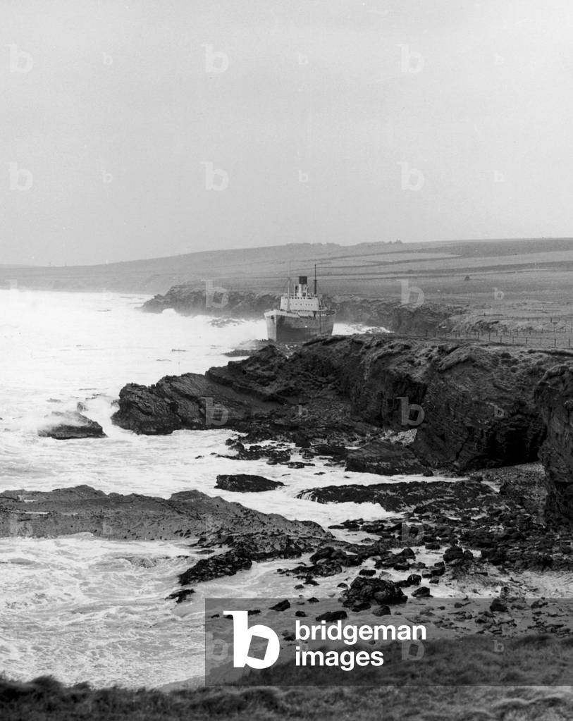 Disaster struck the tiny village of Longhope on the Orkney island of Hoy when eight men from the village lost their lives in a lifeboat disaster, going to help the Liberian cargo ship Irene which had run aground on the neighbouring island of of South Ronaldshay. The ship sent out an SOS and the lifeboat was launched into the mountainous seas of Pentland Firth. The cargo ship is pictured after it had run aground on the rocks, 19th March 1969 (b/w photo)