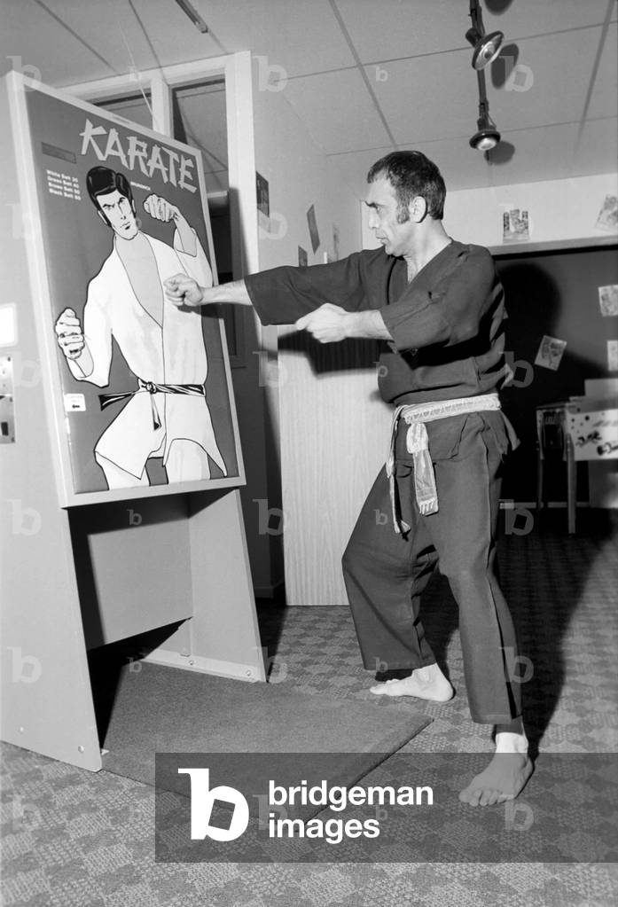 Karate Machine: Man/Machine/Unusual/Humour: Kung Fu man Baron Omidi tries out the new Karate machine at the distributors factory in North West London. February 1975