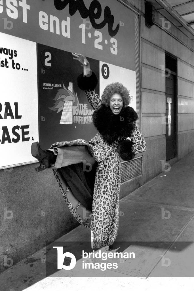 Model Lorne Lesley wearing a long leopard skin coat with fur collar, 27th February 1975 (b/w photo)