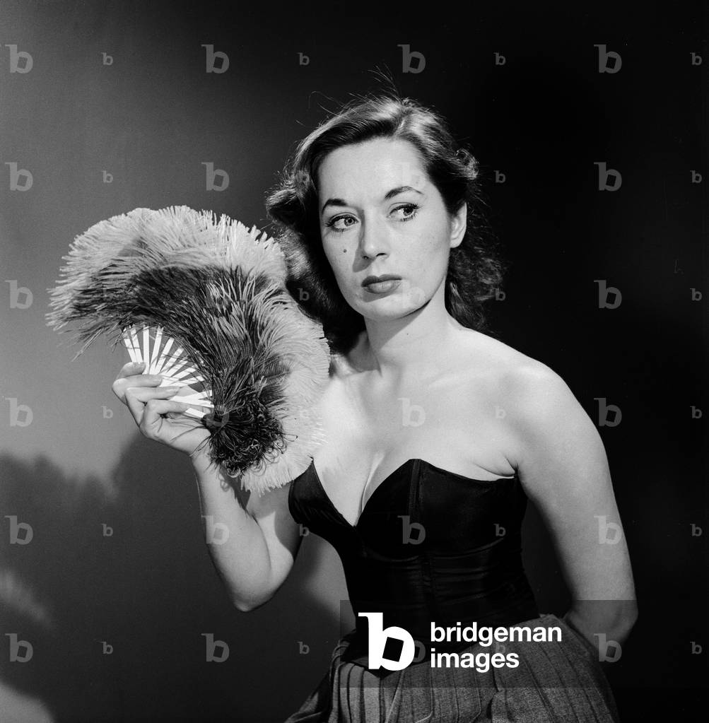 Model with fan in strapless dress. Model with fan in strapless dress, c. 1964 (b/w photo)