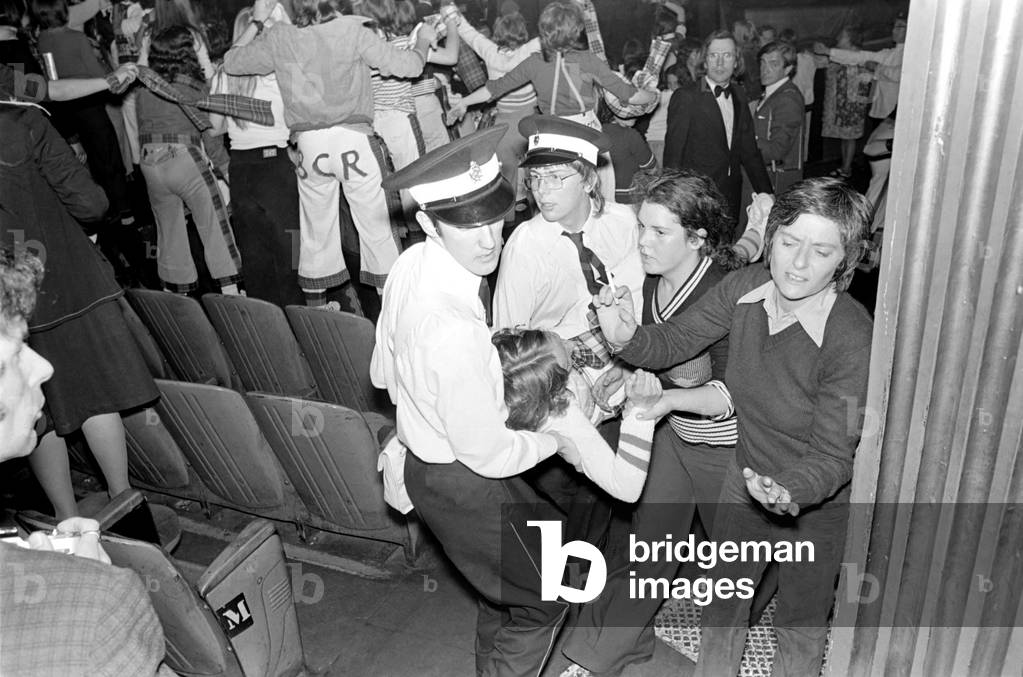 Medical officers attend to injured fans of the Bay City Rollers at their gig in Cardiff, May 1975 (b/w photo)