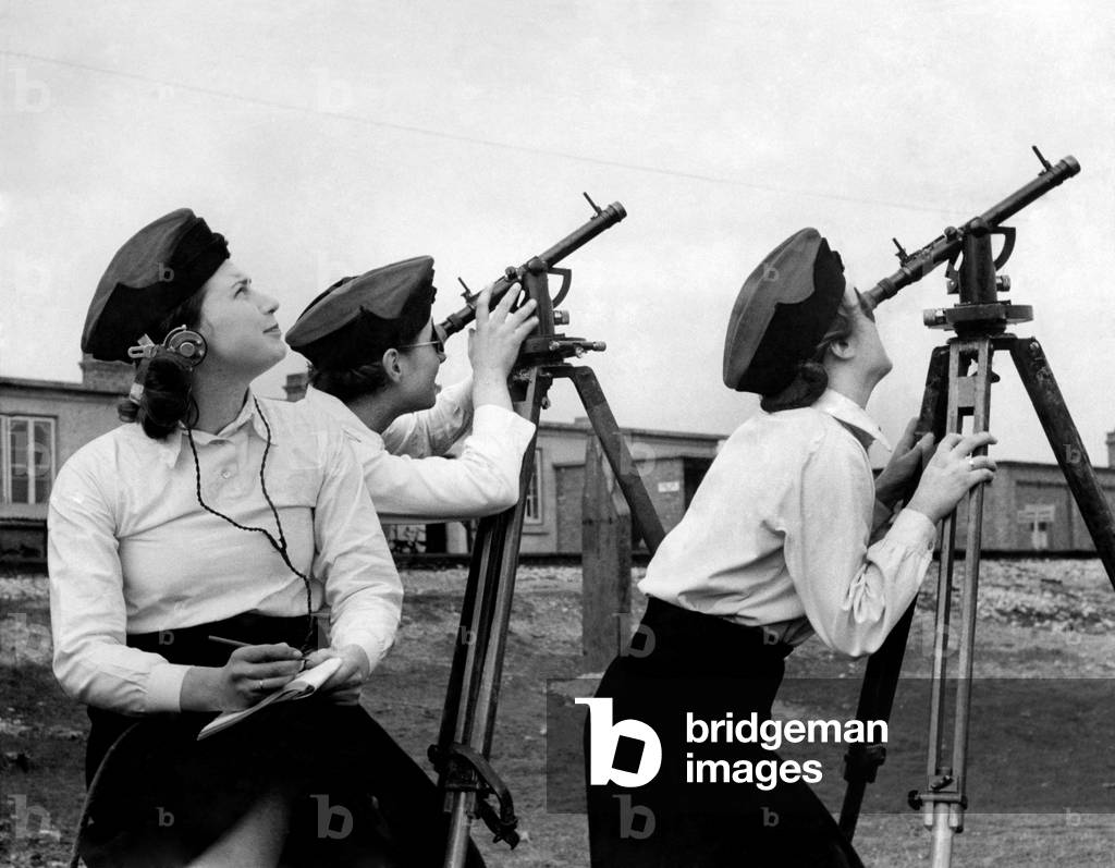 ATS girls at an East Coast Expermental Station. The girls are all specialists and hold degrees. Working on angle of sight instruments on shell bursts. 
March 1941