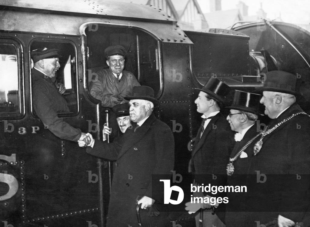 Sir Frederick Stamp, Chairman of the LM+S Railway shakes hands with Mr Fred Davis the Engine Driver of the last steam train journey from Birmingham Park. 15th March 1938.