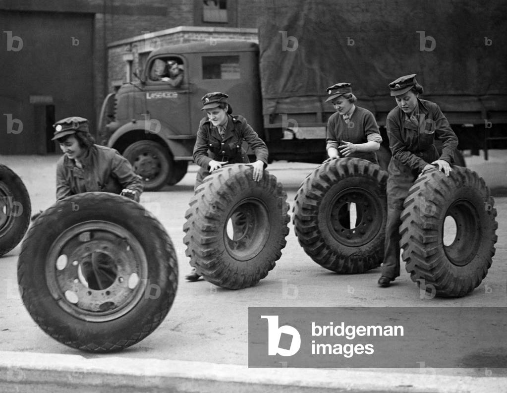 Who pinched the lorry? ATS girls at Western Command Ordinance factory rolling out tyres for Army trucks. Every bit of rubber helps the war effort. October 1942