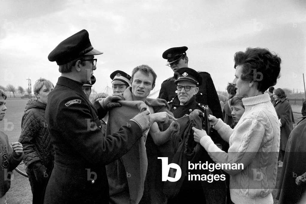 Runner Ken Shaw (29) of Peckham, London , competing in save the children's charity marathon at Liverpool Wanenture playground. St. Johns ambulance men place blanket round Ken Shaw after his marathon run, December 1969 (b/w photo)