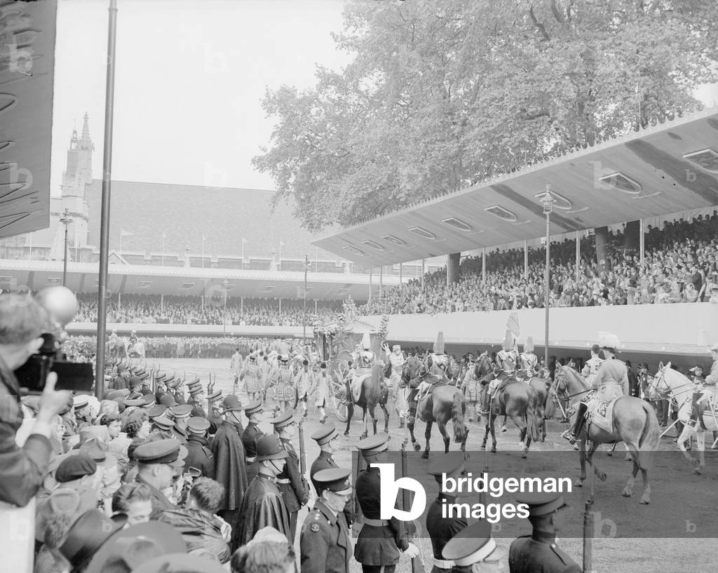 The Coronation of Queen Elizabeth II. A horse drawn carriage, part of the procession leaving Westminster Abbey after the ceremony. 2nd June 1953 (b/w photo)