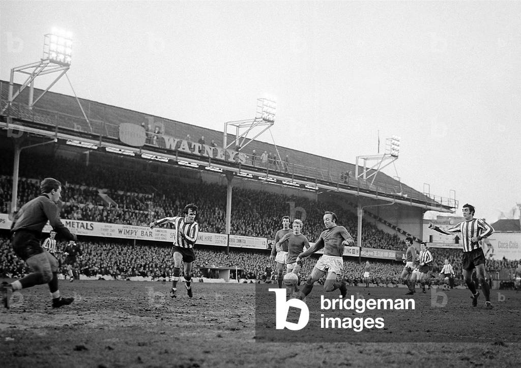 Manchester United defender Nobby Stiles prepares to clear the ball under pressure from Southampton forwards as goalkeeper Alex Stepney comes off his line during their league match at The DellDecember 1968 (photo)