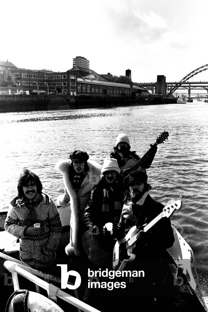 Lindisfarne sailed down the Tyne on a musical journey. The group were filming on board a Tyne ferry for a half-hour television show called 'All Right Now'. (Left to right) Ray Jackson, Ray Laidler, Alan Hull, Si Cowe and Rod Clements, 4th March, 1979 (b/w photo)