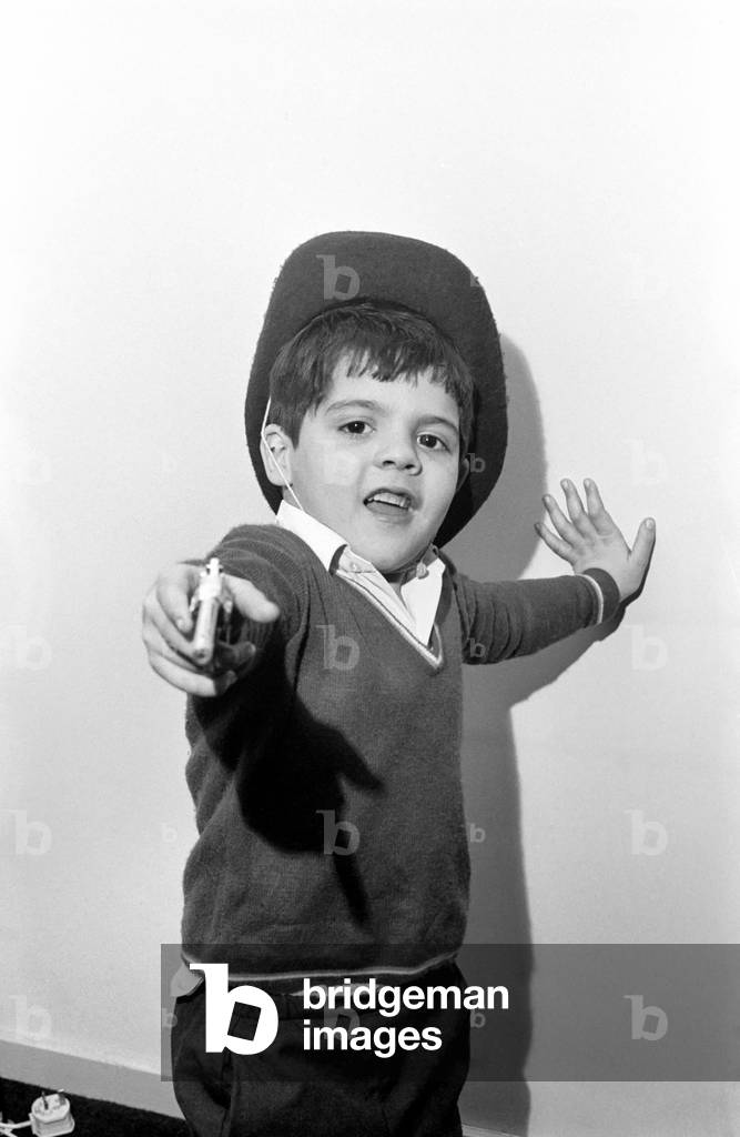 Little abandoned boy who calls himself George Mason settles down in a children's home in Camden, London. Our photographer is firmly in the sights of George's toy gun. December 1969
