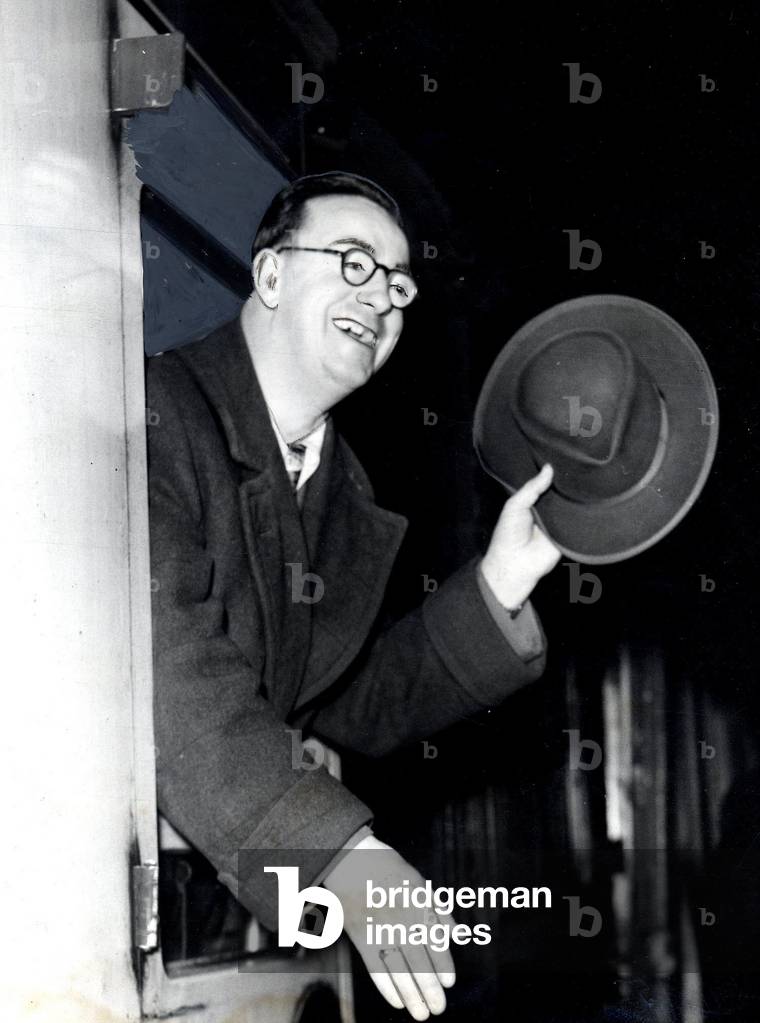 Tommy Gilmour Senior boxing manager promoter waves goodbye from the window of a railway carriage, February 1952 (b/w photo)