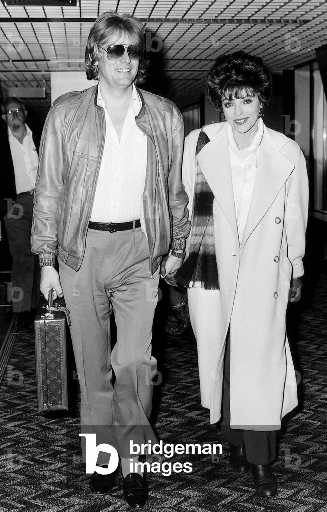Joan Collins British actress arrives at Heathrow with husband Peter in April 1986.