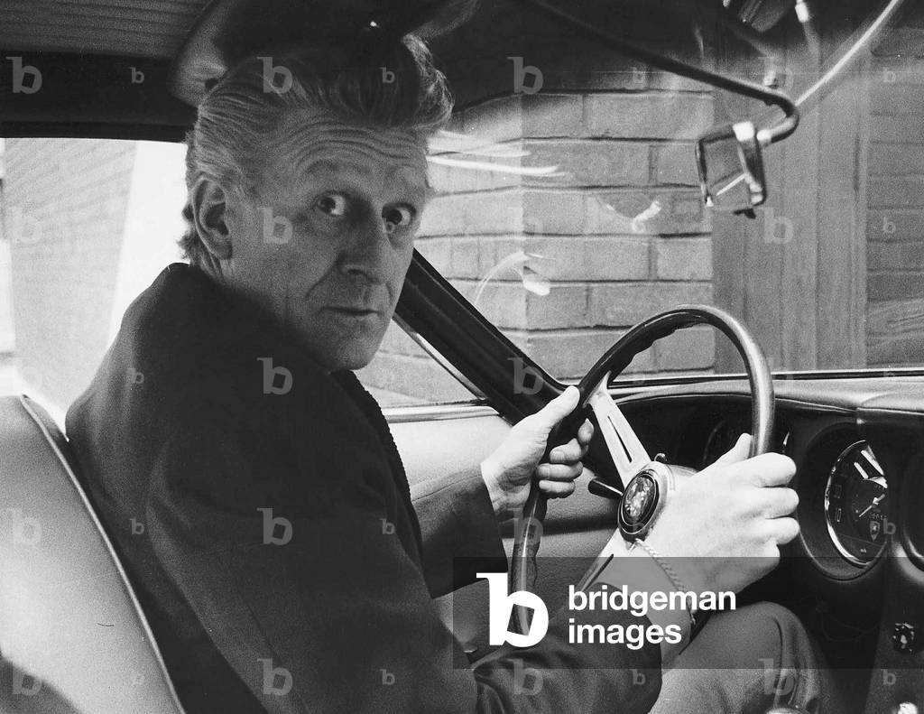 Jon Pertwee actor seated inside one of the £6,500 12 cylinder 170mph lamborghinis flown specially from Italy to be on sale shortly. 1967