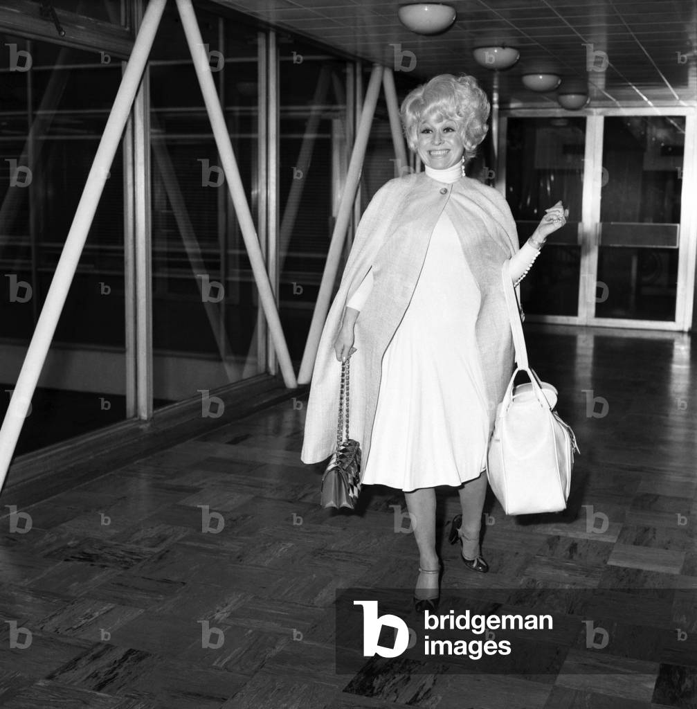 L.A.P. Actress Barbara Windsor. Departure of actress Barbara Windsor from London Airport to New Zealand for a four week tour of her own show 'Carry on Barbara', February 1975