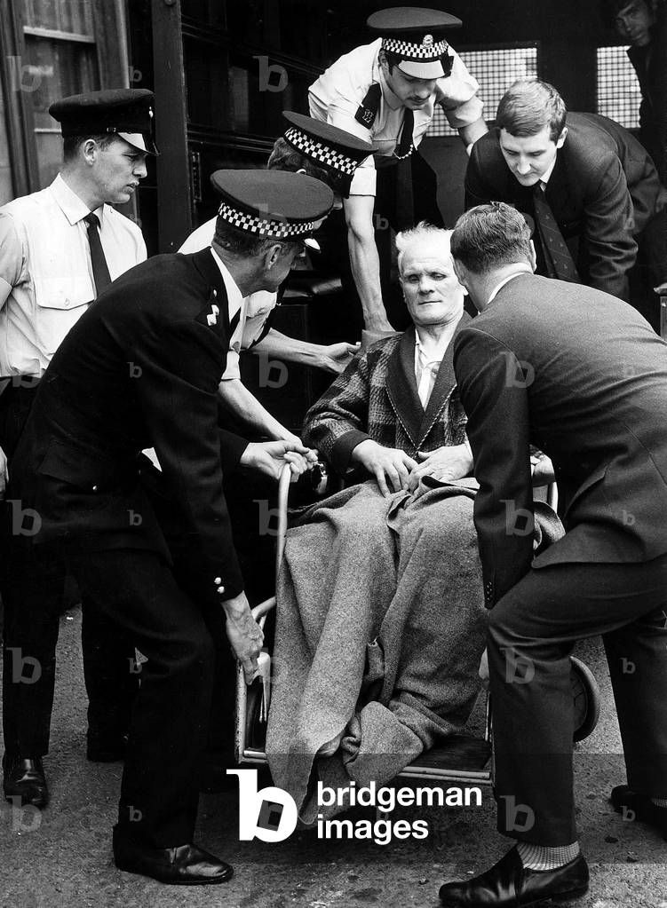 Johnny Ramensky arrives at court, in wheelchair