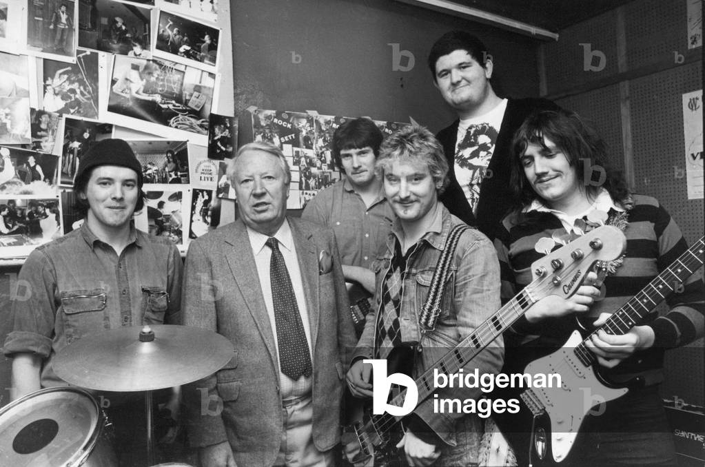 Edward Heath pictured with local band Bill Podmoore's Nose at Derwentside Unemployment Branch - l to r, David Weir, Frank O'Keeffe, Lee Slavin, Charles Chilvers and Paul Kearney, 1980 (b/w photo)