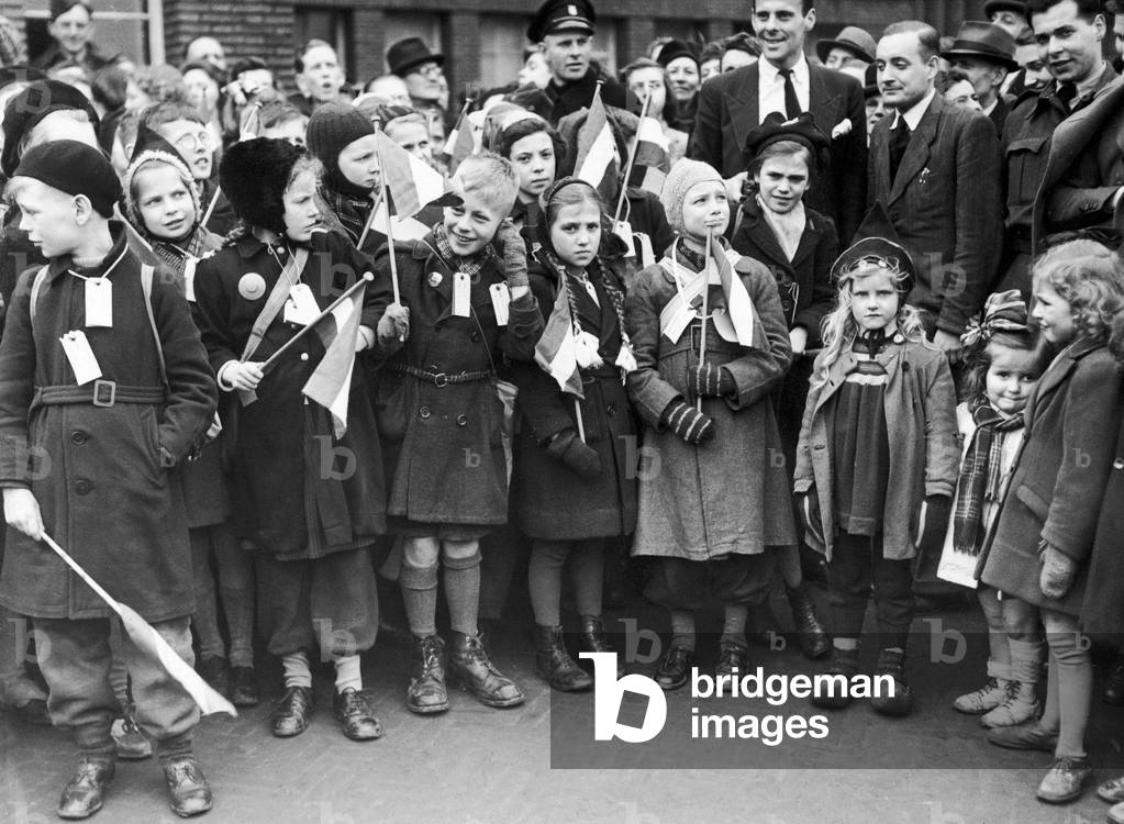 Dutch children being evacuated to Coventry due to lack of food, ready to go after being labelled and given flags in Eindhoven, 9th February 1945 (b/w photo)