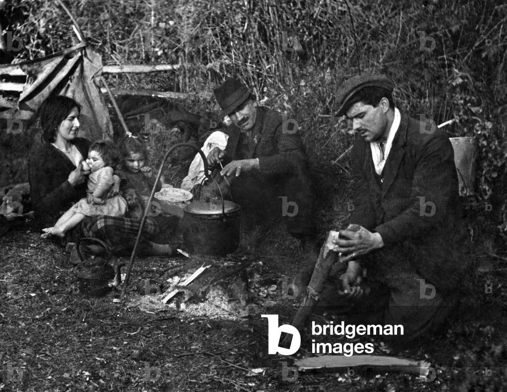 A scene on the road near Ledbury. These gypsies have pulled up by the roadside for their evening meal. February 1944