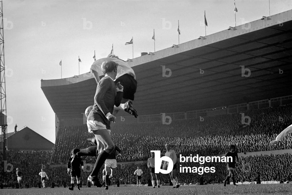 Sport: Football: Manchester United v. Stoke City. Denis Law flicks the ball back with a header to Bobby Charlton (not in pic) who hammers home the ball for United's goal. November 1969 (photo)