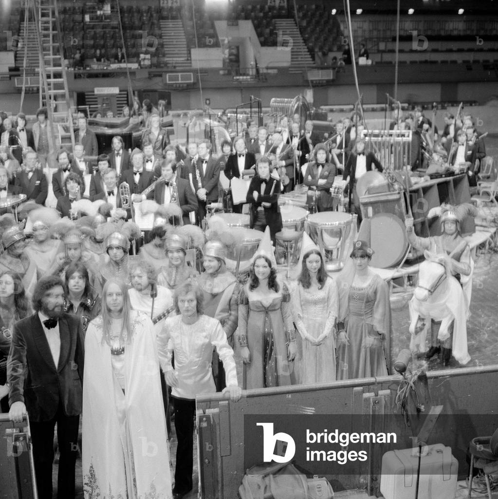 Rick Wakeman and the cast of King Arthur and the Knights of the Round table on ice at the Empire Pool Wembley, May 1975 (b/w photo)