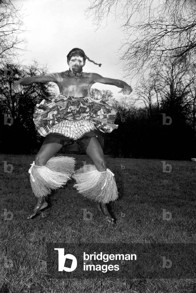 African Dancing: Ghanan Dancers. One of the dancers complete with war paint seen on Hampstead Heath this morning. December 1974