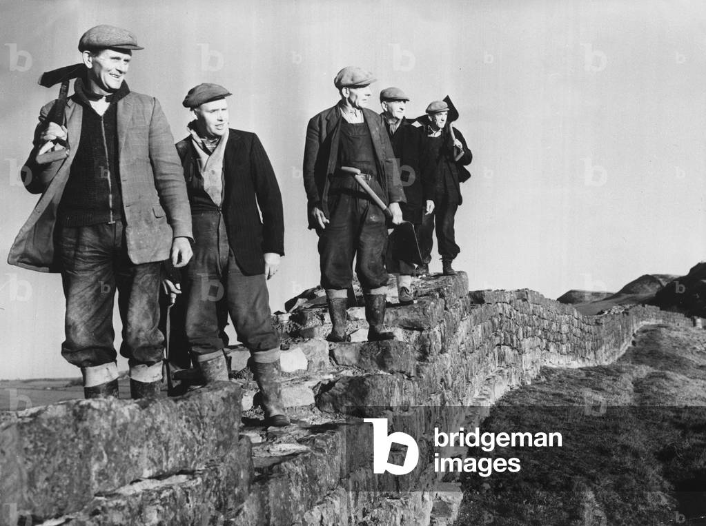 Hadrians Wall - workmen on restoration work pause foor a break as they walk along the wall to the next section for repair.
Northumberland
February 1965