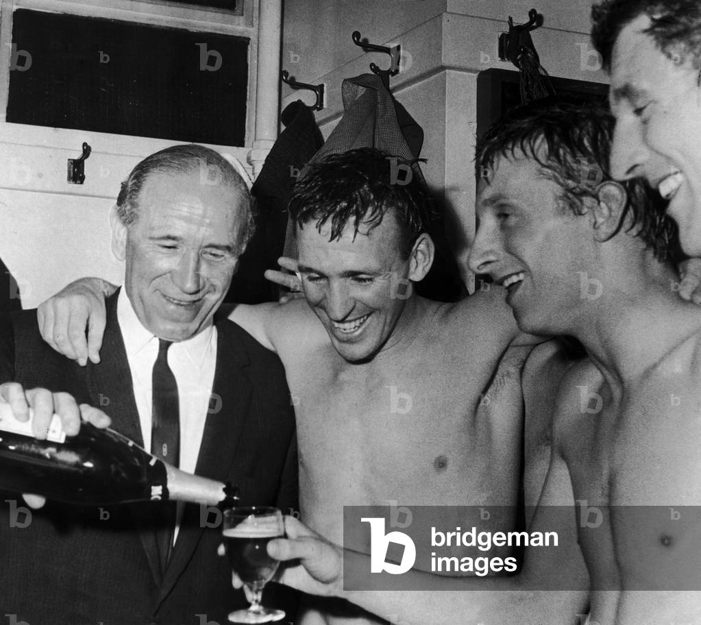 Four Scots with something to celebrate. But the toast isn't in Scotch - it demands something better. Manchester United celebrate being crowned division one champions afterr beating Arsenal three one at Old Trafford. 26th April 1965 (photo)