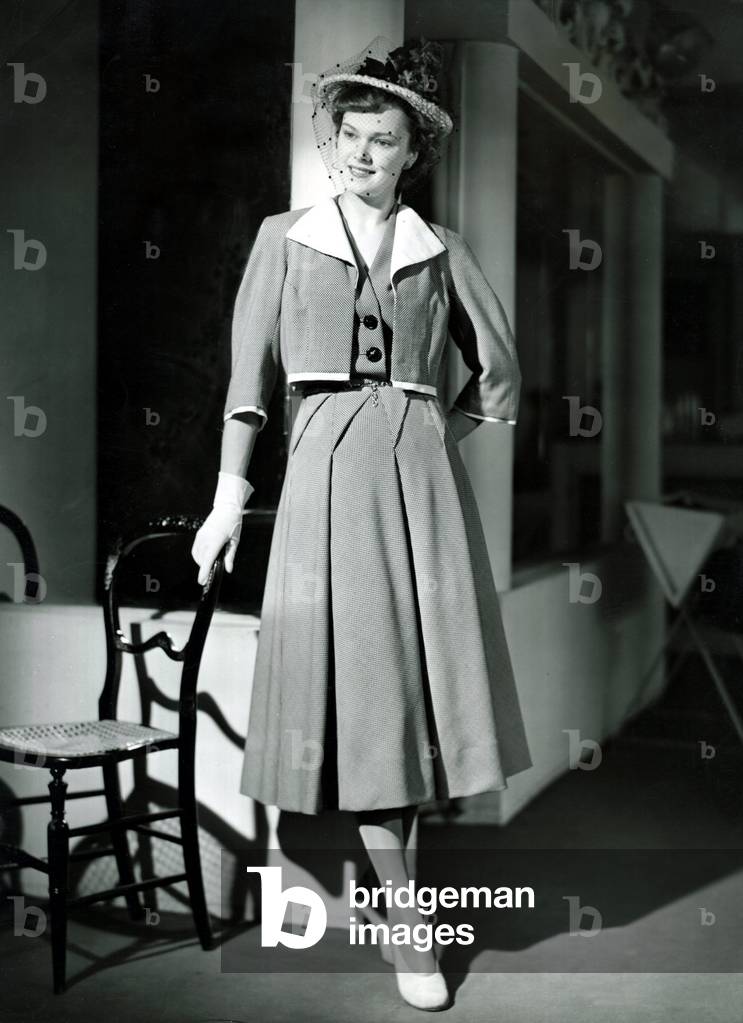 Fashion 1940s Model wearing a Bolero Pleated skirt suit, 1940 (b/w photo)
