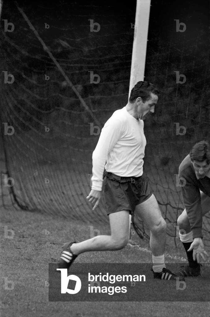Members of the Tottenham Hotspur team training. Dave Mackay practices his tacklingJuly 1965 1965-1971-046 (photo)