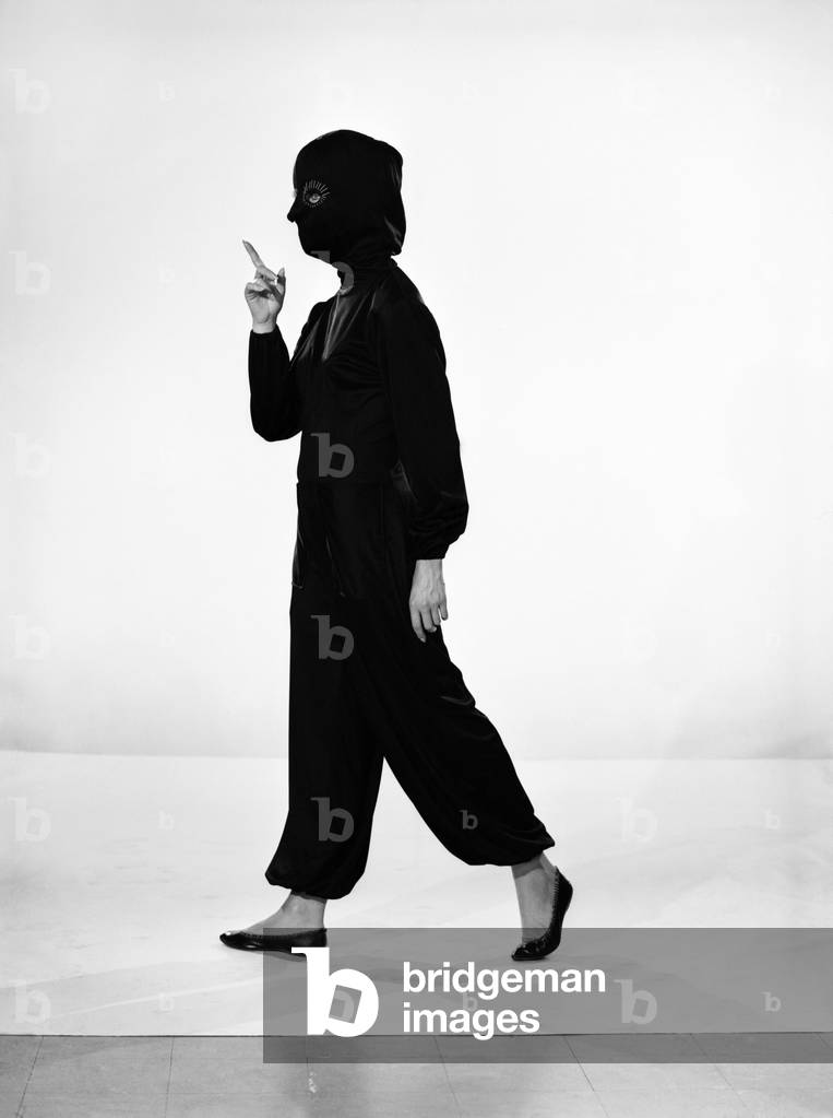 Clothing: Fashion: Suits: Woman wearing space suit. Model: Valerie Gaten. October 1961 (b/w photo)