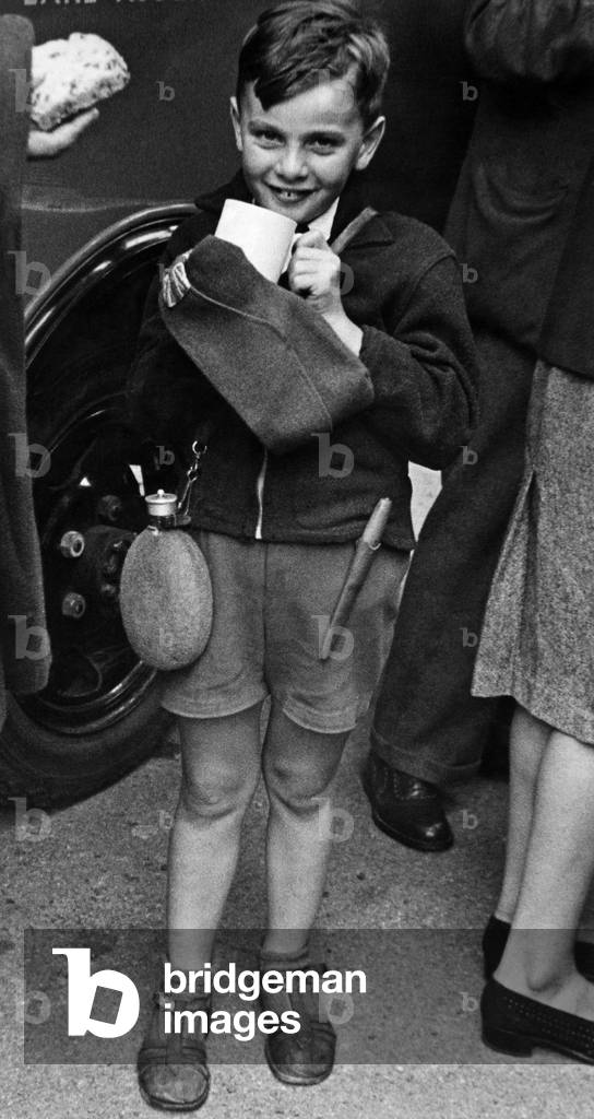 Among the repatriated prisoners who arrived at Addison Road Station today was Jimmy Newman. Here he is drinking his tea at a Red Cross Van with much relish. August 1944