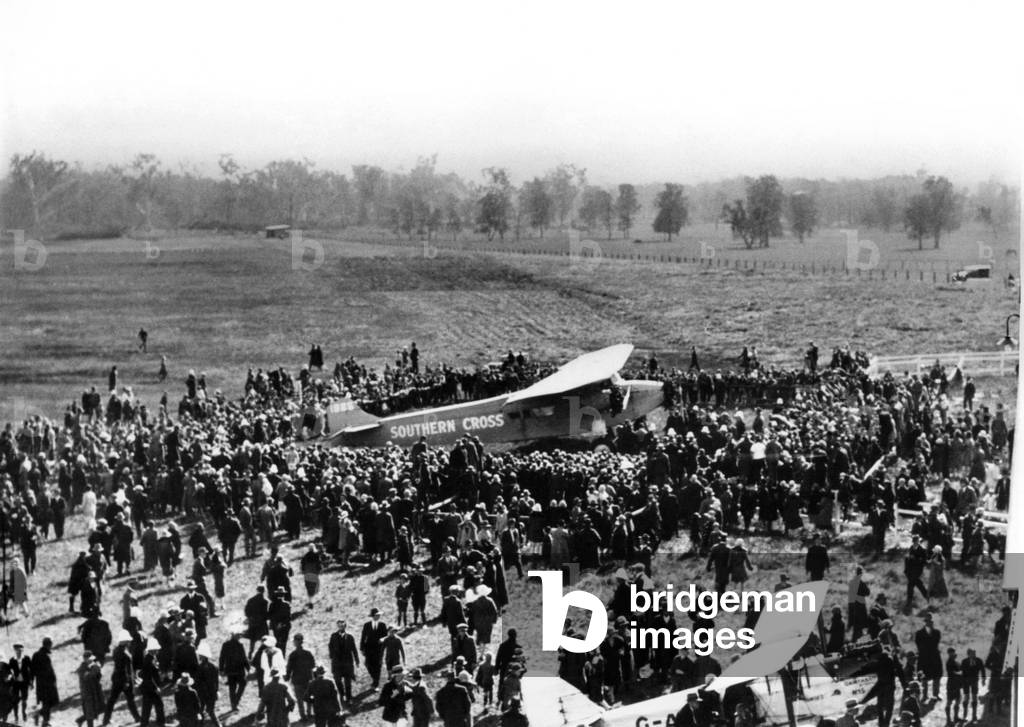 The Mighty Fokker VIII-3M the 'Southern Cross' comes home after the Trans Pacific Flight surrounded by admirers after landing at Brisbane, The escort planes looked like sparrows beside a hawk, 
31/05/1928