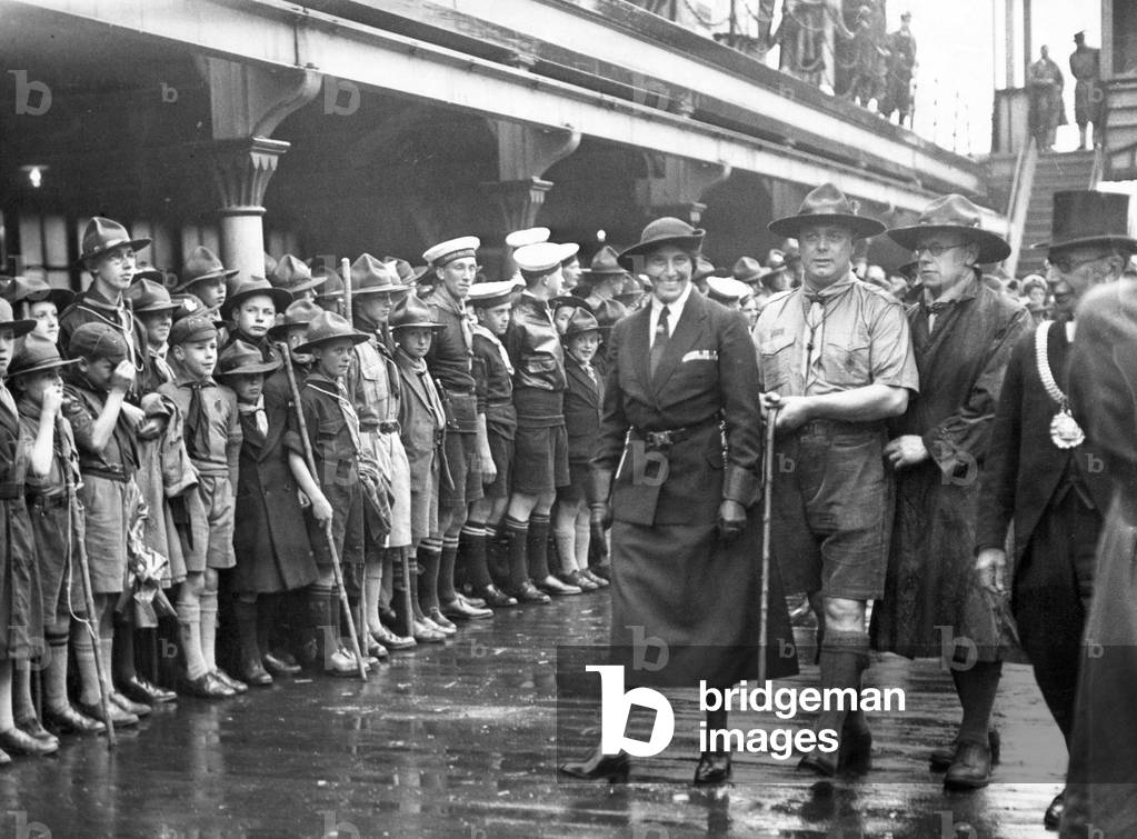 Lady Baden Powell inspects the Guard of Honour before departing with the Chief Scout on the PSNC liner Ordana yesterday. The Lord Mayor and Local scout officials are on the right. August 1938.